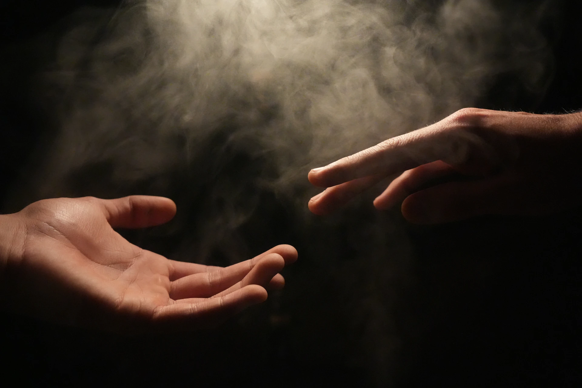 Two hands reaching towards each other, showing the connection AI reads between hand features